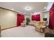 Comfortable living room with carpet, recessed lights, red curtains, and multiple seating arrangements at 1650 Old Loganville Rd, Loganville, GA 30052
