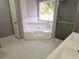 Bathroom showcasing a soaking tub with a corner window, plus tiled floors and shower at 1666 Hearthstone Way, Jonesboro, GA 30236