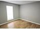 Bright bedroom featuring wood-look flooring, neutral walls, and a window with natural light at 1666 Hearthstone Way, Jonesboro, GA 30236