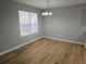 Dining room with wood-look flooring, neutral walls, and a chandelier above the table area at 1666 Hearthstone Way, Jonesboro, GA 30236