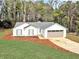 Charming one-story home with an attached garage, fresh landscaping, and a well-manicured lawn at 1666 Hearthstone Way, Jonesboro, GA 30236