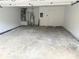 Spacious two car garage with heater, water heater, white walls and trim, gray painted floor, and a service door at 1666 Hearthstone Way, Jonesboro, GA 30236