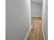 Clean hallway with new flooring, fresh paint, and ample natural light at 1666 Hearthstone Way, Jonesboro, GA 30236