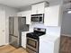 Modern kitchen with stainless steel appliances, white cabinets, and ample countertop space at 1666 Hearthstone Way, Jonesboro, GA 30236