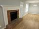 Cozy living room with a brick fireplace, new flooring, and fresh paint at 1666 Hearthstone Way, Jonesboro, GA 30236