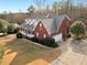 Aerial view of a brick house in a leafy neighborhood at 1000 Eddie Craig Dr, Mcdonough, GA 30252