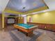 Finished basement featuring a pool table, a cloud-painted ceiling and a projector screen at 1000 Eddie Craig Dr, Mcdonough, GA 30252