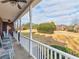 A view of the front porch with a blue-painted rocking chair at 1000 Eddie Craig Dr, Mcdonough, GA 30252