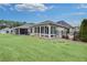 Spacious backyard featuring a screened porch, sunroom, and lush green lawn, perfect for outdoor living at 117 Clover Way, Woodstock, GA 30188