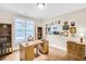 Office with hardwood floors, built-in bookshelves, desk, window, and decorated with framed military memorabilia at 117 Clover Way, Woodstock, GA 30188