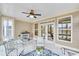 Cozy sunroom area featuring a tiled floor, fireplace, neutral paint, and comfortable furniture at 117 Clover Way, Woodstock, GA 30188