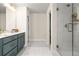 Modern bathroom featuring a double sink vanity, tiled shower with glass door and neutral color palette at 4220 Cavalier Way, Duluth, GA 30097