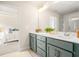 Modern bathroom featuring dual sink vanity, decorative light fixture, and view to bedroom at 4220 Cavalier Way, Duluth, GA 30097