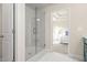 Bathroom featuring glass-enclosed shower, door to bedroom, and neutral color palette at 4220 Cavalier Way, Duluth, GA 30097