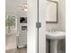 View from door of a bathroom with a pedestal sink, mirror, and view to the living room at 4220 Cavalier Way, Duluth, GA 30097