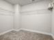 Walk-in closet featuring carpet and white wire shelving system for optimal storage solutions at 4220 Cavalier Way, Duluth, GA 30097