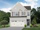 Charming two-story home with white brick, a two-car garage, and lush landscaping at 4220 Cavalier Way, Duluth, GA 30097