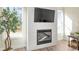 Close-up view of a modern fireplace with shiplap surround, and an adjacent houseplant at 4220 Cavalier Way, Duluth, GA 30097