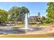 Community fountain with landscaped grounds and clock tower building in the background at 4220 Cavalier Way, Duluth, GA 30097