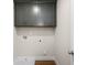 Clean laundry room with gray cabinets, utility sink, and wood-look flooring at 4220 Cavalier Way, Duluth, GA 30097