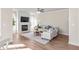Bright living room features a fireplace, large TV, ceiling fan, and stylish decor at 4220 Cavalier Way, Duluth, GA 30097