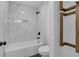 This bathroom features a combined shower and tub and has marble-patterned tiled walls at 131 Old Alabama Se Rd, Emerson, GA 30137