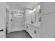 Elegant bathroom featuring double sinks, white cabinets, quartz countertops, and a walk-in shower at 131 Old Alabama Se Rd, Emerson, GA 30137