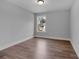 This bedroom has a big window, base trim and wood flooring at 131 Old Alabama Se Rd, Emerson, GA 30137