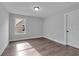 This bedroom has a big window, base trim and wood flooring at 131 Old Alabama Se Rd, Emerson, GA 30137