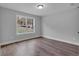 This bedroom is a relaxing retreat with wood flooring, grey paint, and a bright window at 131 Old Alabama Se Rd, Emerson, GA 30137