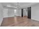 Bright bedroom featuring wood floors, a tray ceiling, a stylish chandelier, and a walk-in closet with sliding barn doors at 131 Old Alabama Se Rd, Emerson, GA 30137