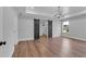 Spacious bedroom featuring wood floors, stylish lighting, tray ceiling, and a walk-in closet with sliding barn doors at 131 Old Alabama Se Rd, Emerson, GA 30137
