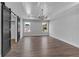 Open bedroom featuring wood floors, stylish lighting, tray ceiling, and a walk-in closet with sliding barn doors at 131 Old Alabama Se Rd, Emerson, GA 30137