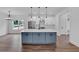 Stylish kitchen with white cabinets, a blue island, stainless steel appliances, and pendant lighting at 131 Old Alabama Se Rd, Emerson, GA 30137