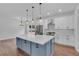Bright kitchen featuring a blue island with a white countertop and stainless steel appliances at 131 Old Alabama Se Rd, Emerson, GA 30137