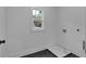 Simple laundry room with a small window and hookups for a washer and dryer at 131 Old Alabama Se Rd, Emerson, GA 30137
