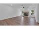 Bright living room with a brick fireplace, hardwood floors, and ample natural light at 131 Old Alabama Se Rd, Emerson, GA 30137