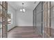 Bright office featuring stylish gray paneled wall, hardwood floors, contemporary chandelier, and an abundance of natural light at 131 Old Alabama Se Rd, Emerson, GA 30137
