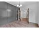 View of office features a stylish gray paneled wall, hardwood floors, contemporary chandelier, and an open view to hallway at 131 Old Alabama Se Rd, Emerson, GA 30137