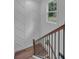 This stairwell boasts of lovely wall paneling detail, dark metal railings, and gleaming, modern design at 131 Old Alabama Se Rd, Emerson, GA 30137