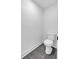 This bathroom features a white commode with gray tile flooring and white walls at 131 Old Alabama Se Rd, Emerson, GA 30137