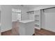 Spacious walk-in closet featuring custom shelves, rods, and a center island with a white countertop at 131 Old Alabama Se Rd, Emerson, GA 30137