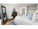 Well-lit bedroom with a large bed, dark dresser, decor, and ample storage at 215 Piedmont Ne Ave # 308, Atlanta, GA 30308