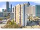 Exterior view of high-rise apartment building in the city, parking lot, and bridge in the foreground at 215 Piedmont Ne Ave # 308, Atlanta, GA 30308
