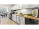 Well-lit kitchen with white cabinets, wood countertops, and modern appliances at 215 Piedmont Ne Ave # 308, Atlanta, GA 30308