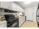 Kitchen featuring black appliances and white cabinets at 215 Piedmont Ne Ave # 308, Atlanta, GA 30308