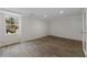 Finished basement space with wood-look tile flooring, a window, and a glass door at 2321 Birdie Ln, Duluth, GA 30096