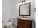 Bathroom featuring toilet, vanity with sink, mirror and tile floors at 2321 Birdie Ln, Duluth, GA 30096