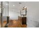 Bathroom features a double vanity with a decorative mirror, hardwood floors, and bead board walls at 2321 Birdie Ln, Duluth, GA 30096