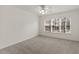 Spacious bedroom with neutral carpet, large windows, and a ceiling fan at 2321 Birdie Ln, Duluth, GA 30096